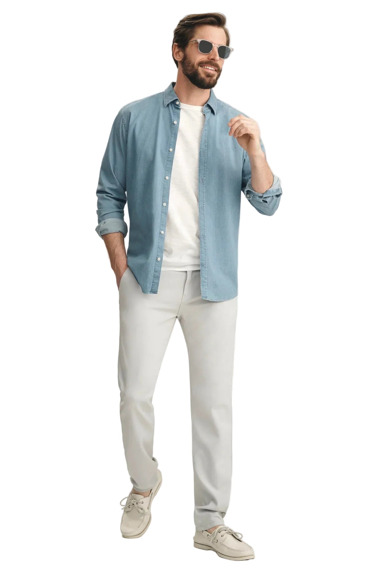 Man wearing a light blue denim shirt, white t-shirt, light gray pants, and beige sneakers on a white background