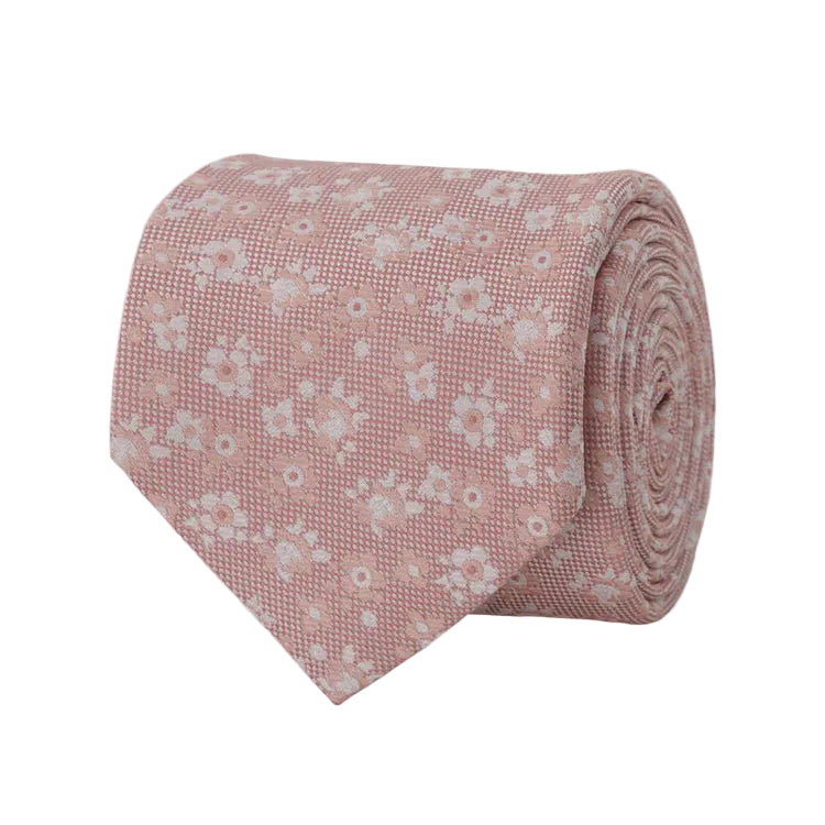 Pink floral tie rolled up on a light gray background