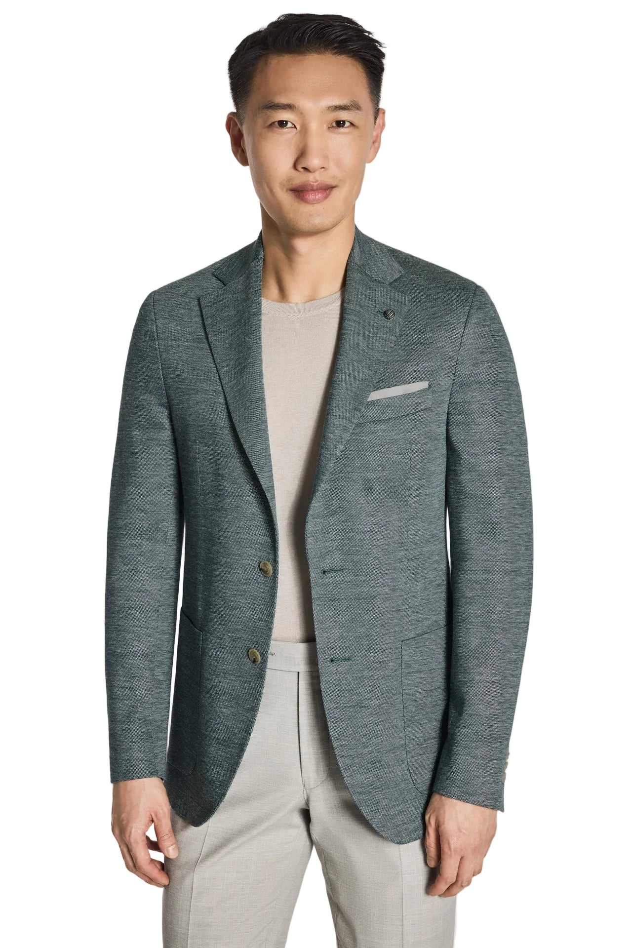 Man wearing a gray blazer over a light gray shirt and pants on a white background