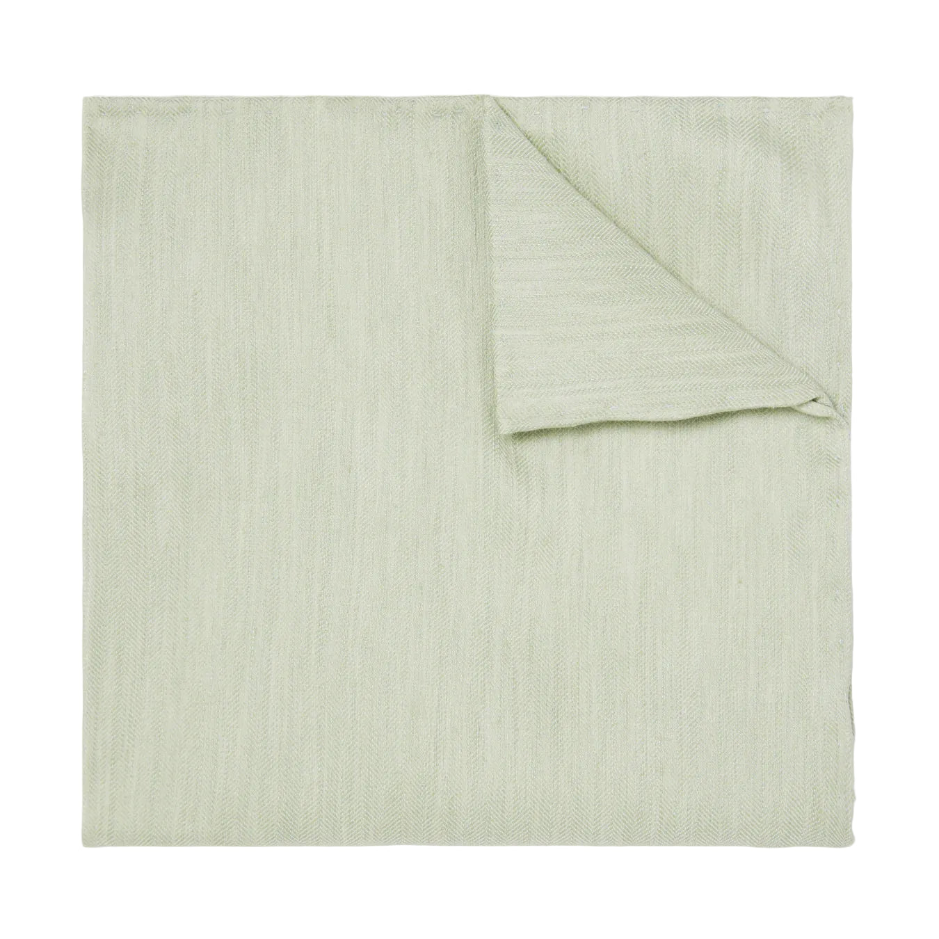 Folded light green fabric on a white background
