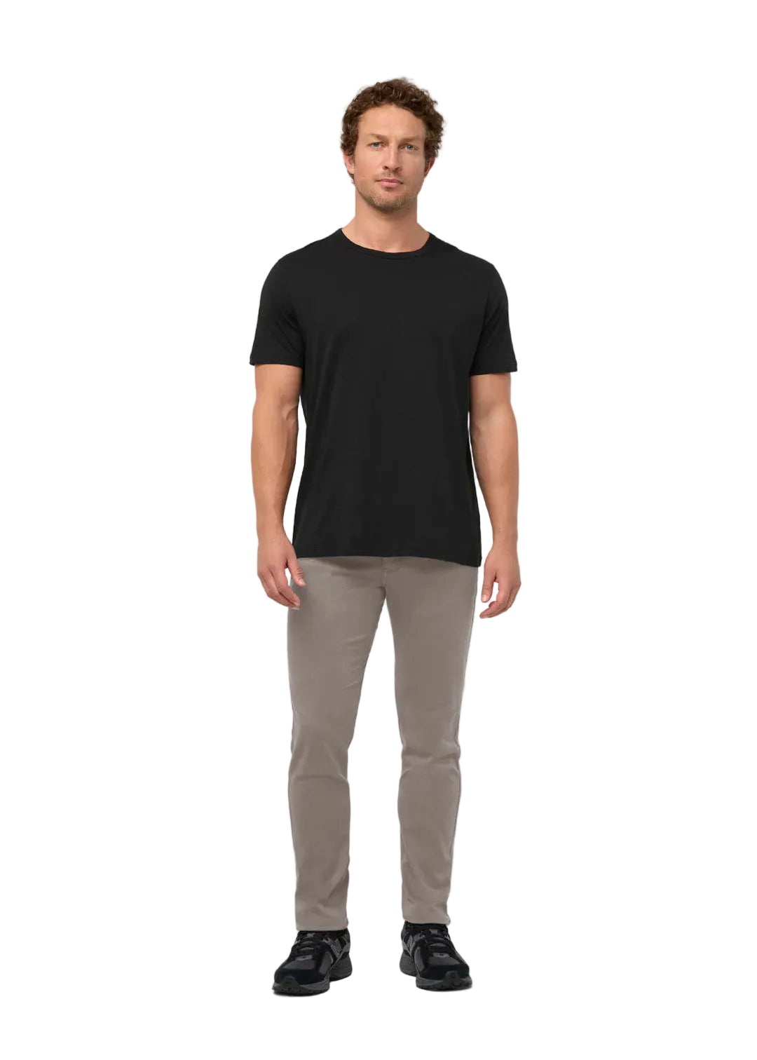 Man wearing a black t-shirt and beige pants on a white background